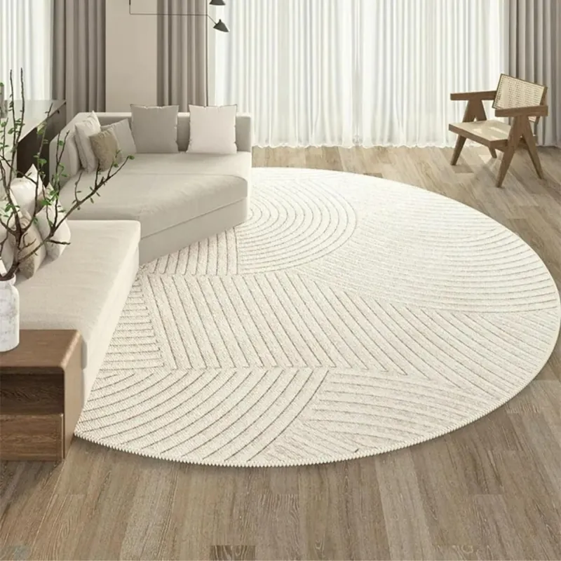 Cream round area rug with carved geometric patterns