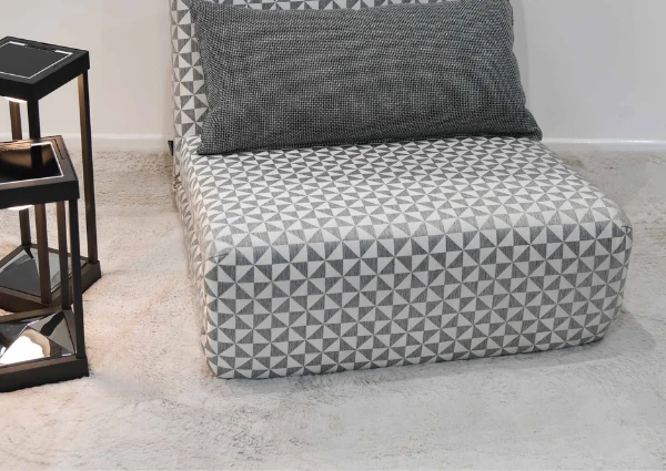 Geometric-patterned-chair-on-soft-fluffy-rug-with-lamps