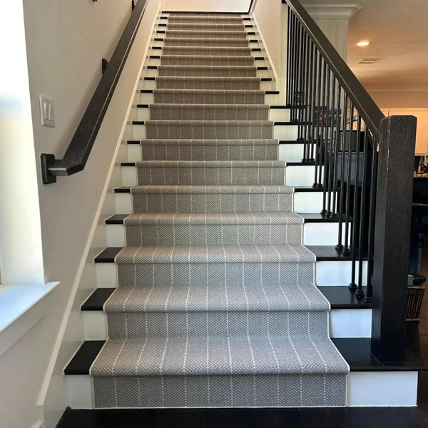 Grey herringbone patterned stair carpet runner on staircase
